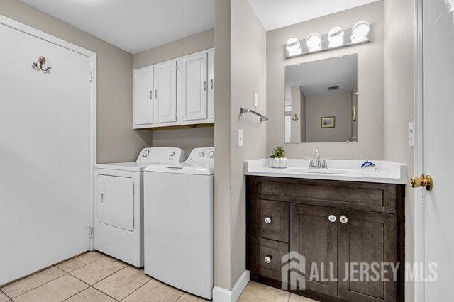 175 Portland Ln Unit C, Monroe, NJ 08831 - laundry room with light tile patterned floors, a sink, baseboards, washer and dryer, and cabinet space