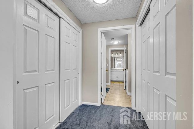 175 Portland Ln Unit C, Monroe, NJ 08831 - hall with baseboards, tile patterned flooring, a textured ceiling, and carpet
