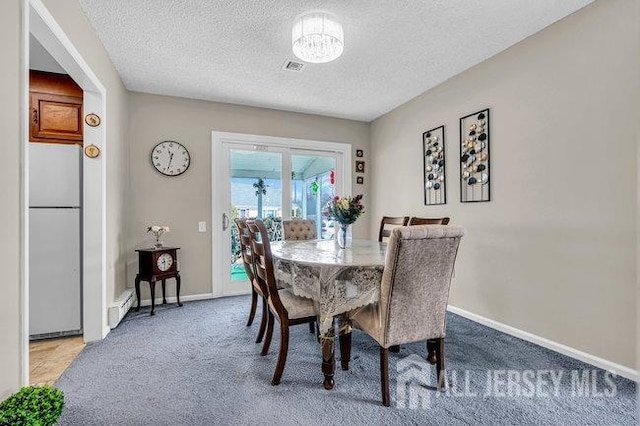 dining space with visible vents, a baseboard heating unit, baseboards, carpet flooring, and a textured ceiling