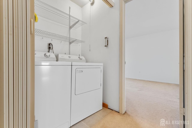 washroom featuring separate washer and dryer and light carpet