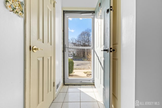 doorway to outside featuring light tile patterned floors