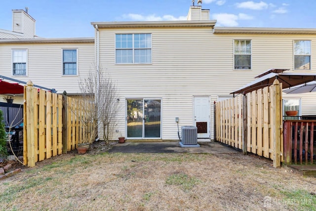 rear view of house featuring central air condition unit