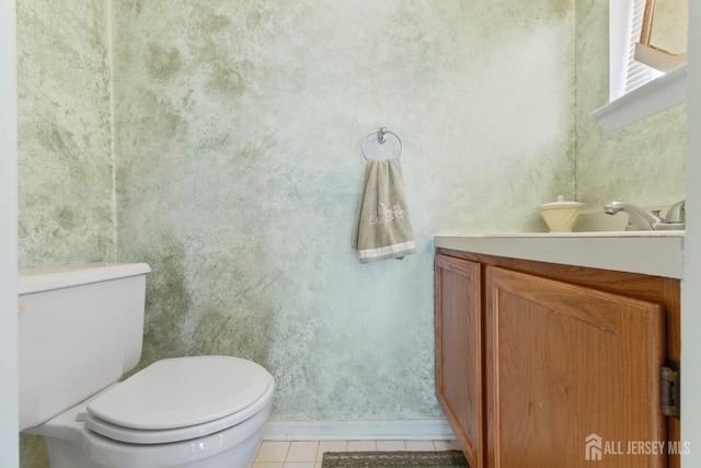 bathroom featuring vanity, toilet, and tile patterned flooring