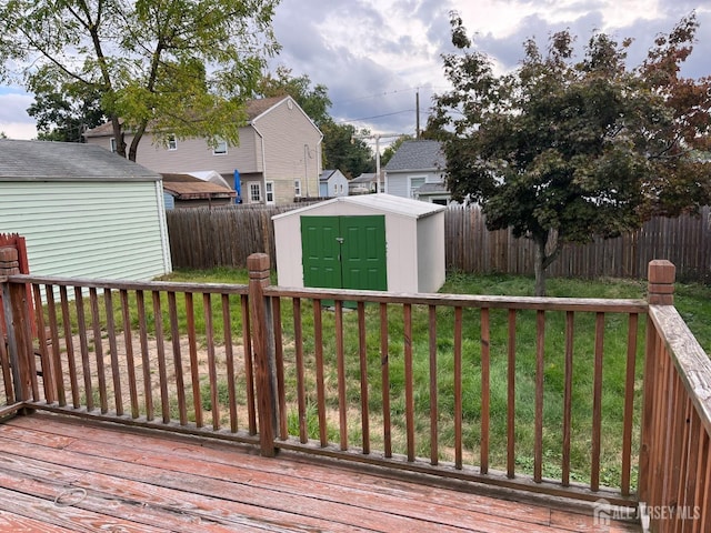 deck featuring a lawn and a shed