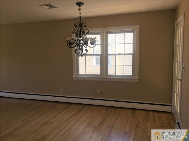 unfurnished dining area with a baseboard radiator, a notable chandelier, visible vents, and wood finished floors