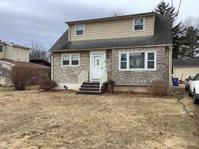 view of front of property featuring a shingled roof and stone siding