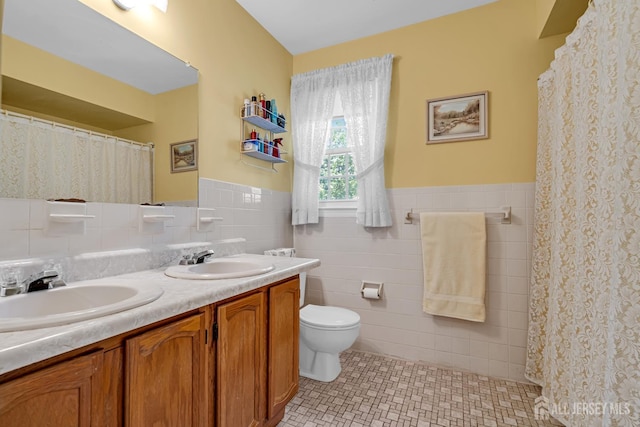 21 Van Hise Ct, East Brunswick, NJ 08816 - full bathroom with tile walls, double vanity, wainscoting, tile patterned floors, and a shower with shower curtain