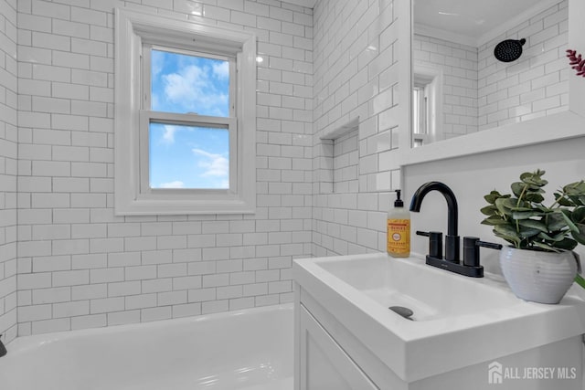 bathroom featuring bathtub / shower combination and vanity