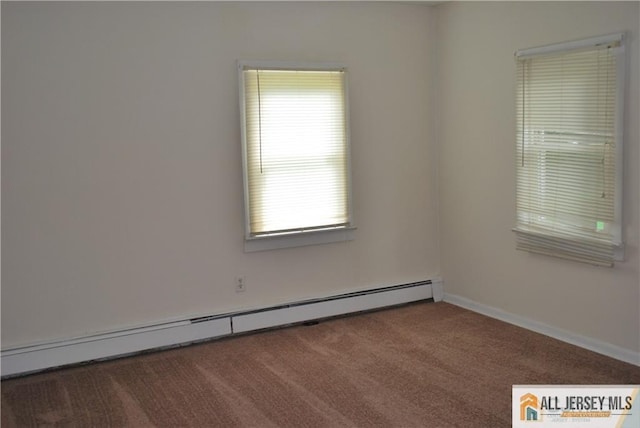 empty room featuring baseboards, carpet flooring, and baseboard heating