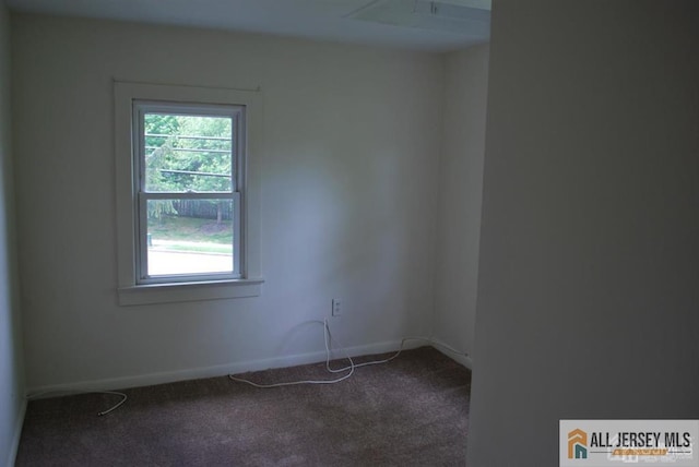 empty room with baseboards and carpet
