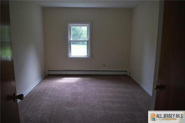 empty room with carpet flooring, baseboards, and a baseboard heating unit