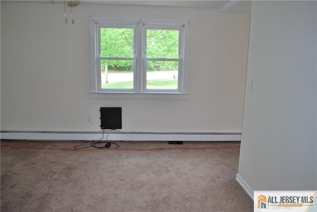 carpeted empty room featuring baseboards and a baseboard heating unit