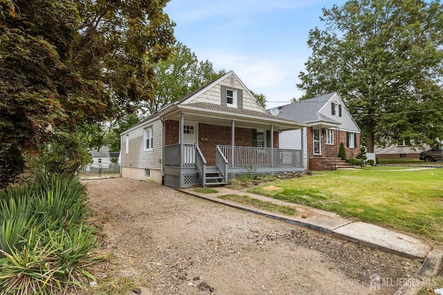 view of front facade with a porch and a front lawn