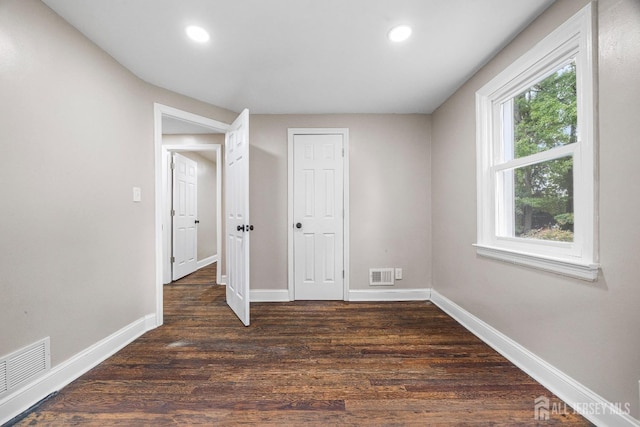 interior space with dark hardwood / wood-style flooring