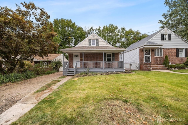 bungalow with a front yard and covered porch