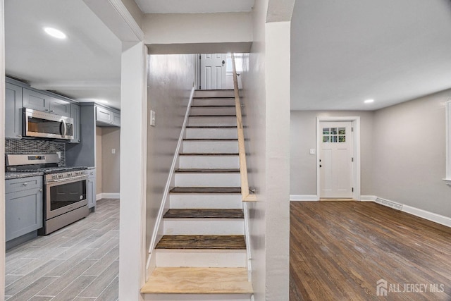 stairway with hardwood / wood-style flooring