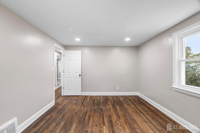 empty room featuring dark hardwood / wood-style flooring