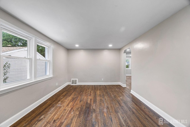 spare room featuring dark wood-type flooring