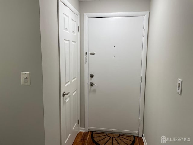 doorway to outside with dark wood-type flooring