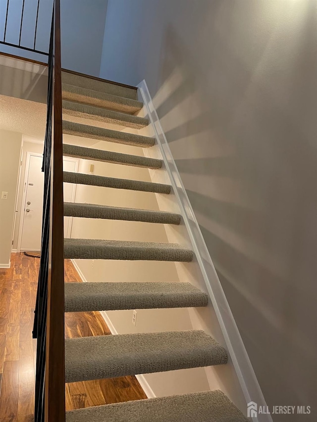 staircase featuring hardwood / wood-style flooring