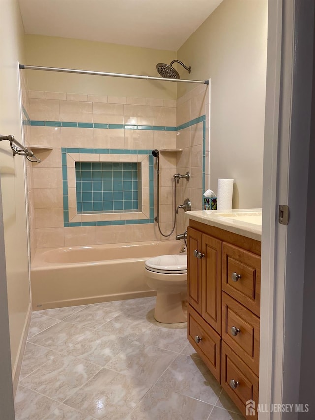 full bathroom with toilet, vanity, and tiled shower / bath combo