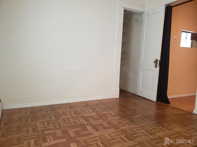 unfurnished room featuring baseboards