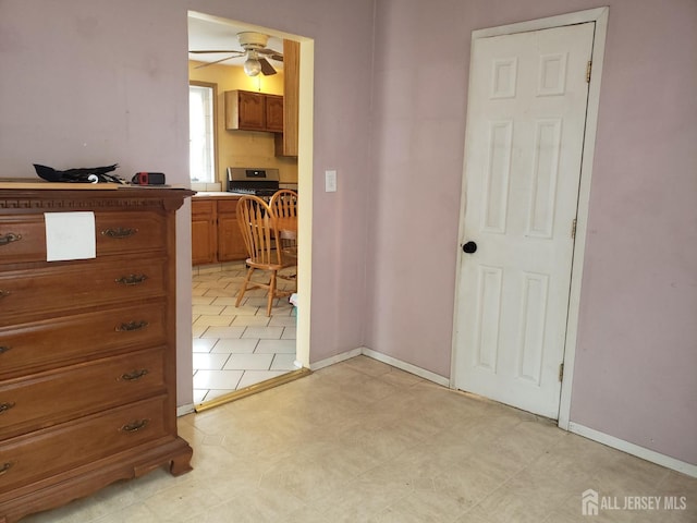 unfurnished bedroom featuring light floors and baseboards