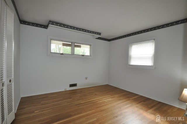 19 Clark Pl, Avenel, NJ 07001 - unfurnished bedroom featuring multiple windows and wood finished floors