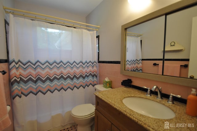 19 Clark Pl, Avenel, NJ 07001 - bathroom featuring vanity, tile walls, a shower with curtain, and a wainscoted wall