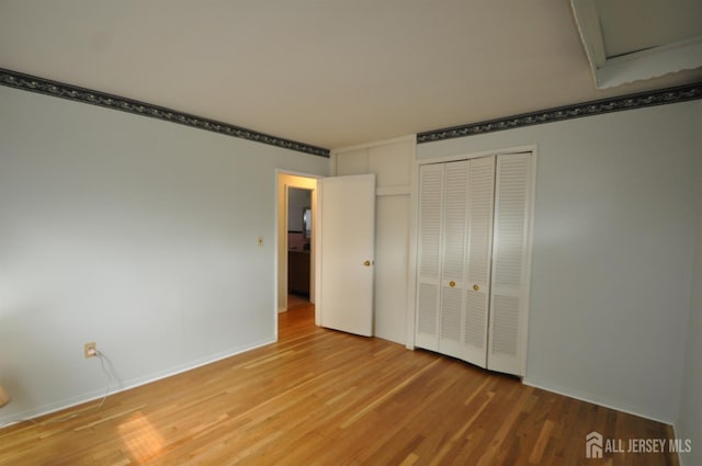 19 Clark Pl, Avenel, NJ 07001 - unfurnished bedroom featuring wood finished floors, attic access, and a closet