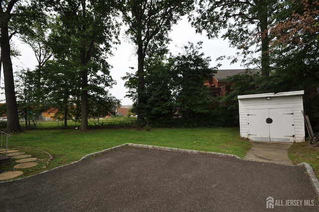 19 Clark Pl, Avenel, NJ 07001 - view of grassy yard featuring a shed and a patio