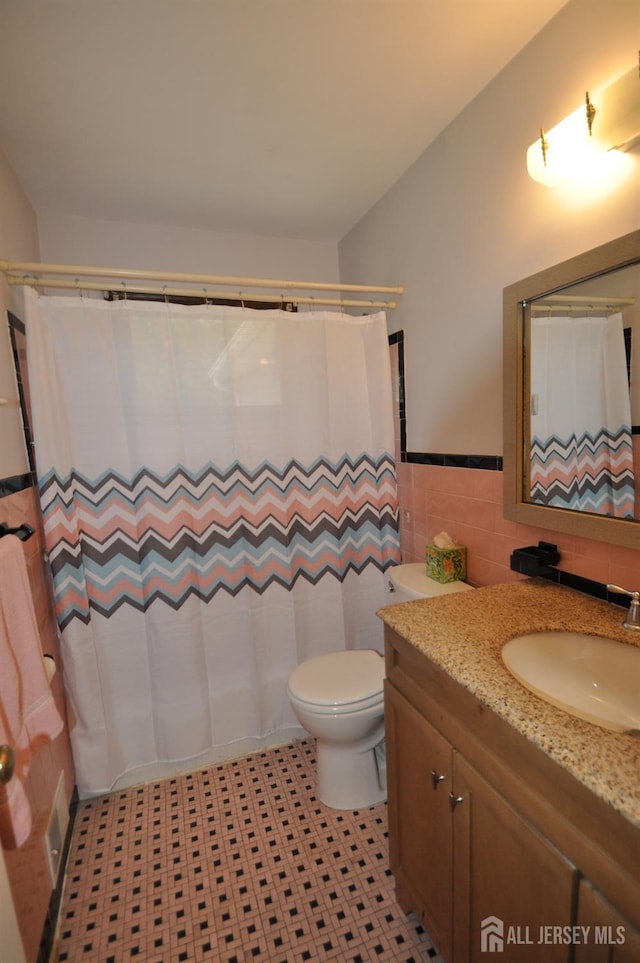 19 Clark Pl, Avenel, NJ 07001 - full bath with tile walls, vanity, wainscoting, and a shower with shower curtain
