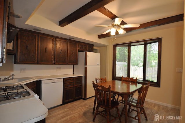 19 Clark Pl, Avenel, NJ 07001 - kitchen with white appliances, dark brown cabinetry, beam ceiling, light countertops, and light wood-type flooring