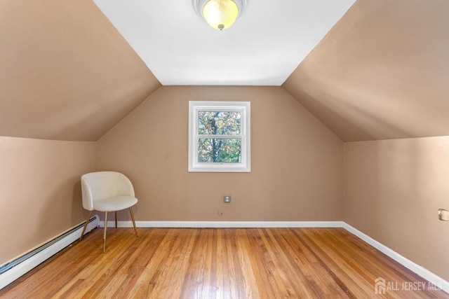 bonus room featuring light hardwood / wood-style flooring, a baseboard heating unit, and lofted ceiling