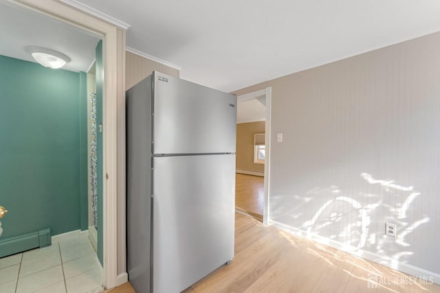 corridor with a baseboard radiator and light wood-type flooring