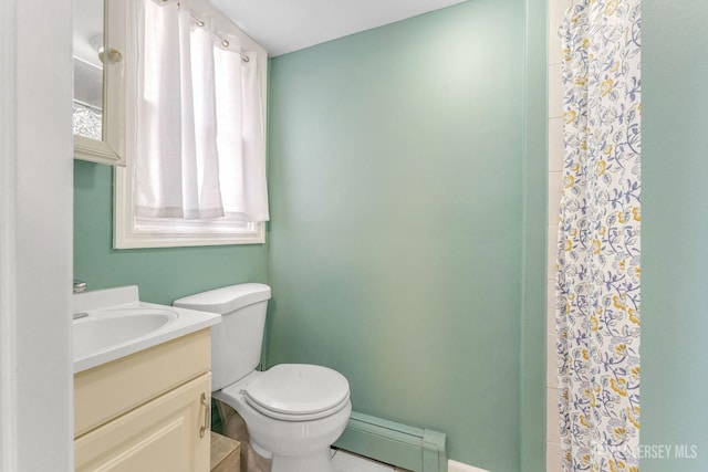 bathroom featuring vanity, toilet, and a baseboard heating unit