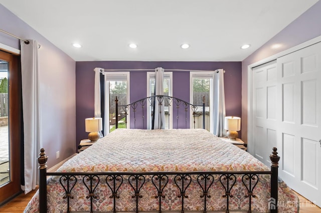 bedroom with access to exterior, wood finished floors, baseboards, recessed lighting, and a closet