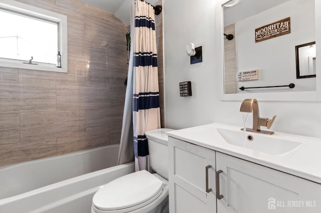 bathroom featuring toilet, shower / bathtub combination with curtain, and vanity