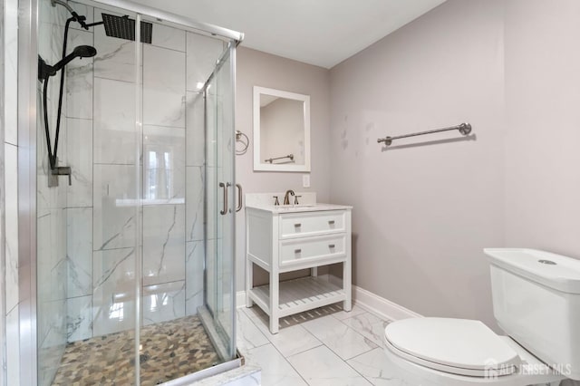 bathroom featuring toilet, marble look tile flooring, a shower stall, and vanity