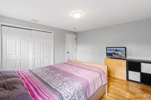bedroom with a closet and light wood-style floors