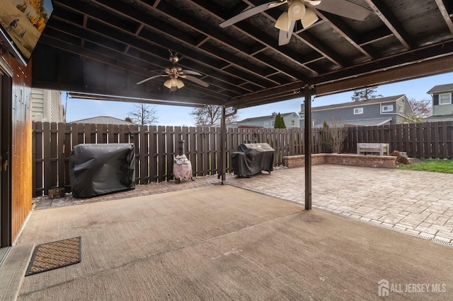 view of patio / terrace with ceiling fan, a fenced backyard, and area for grilling