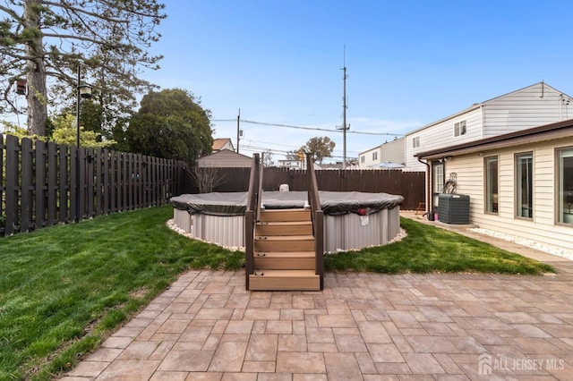 view of patio with a jacuzzi and cooling unit