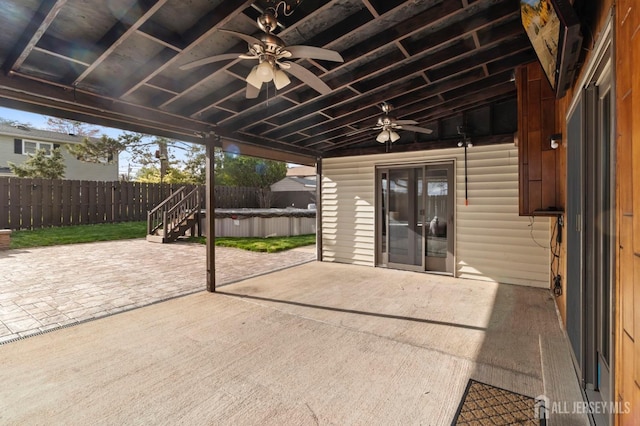 view of patio / terrace featuring ceiling fan, a jacuzzi, and a fenced backyard