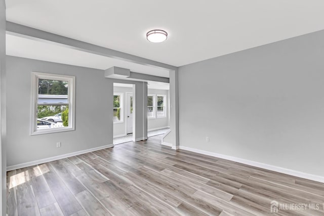 unfurnished room with wood finished floors and baseboards