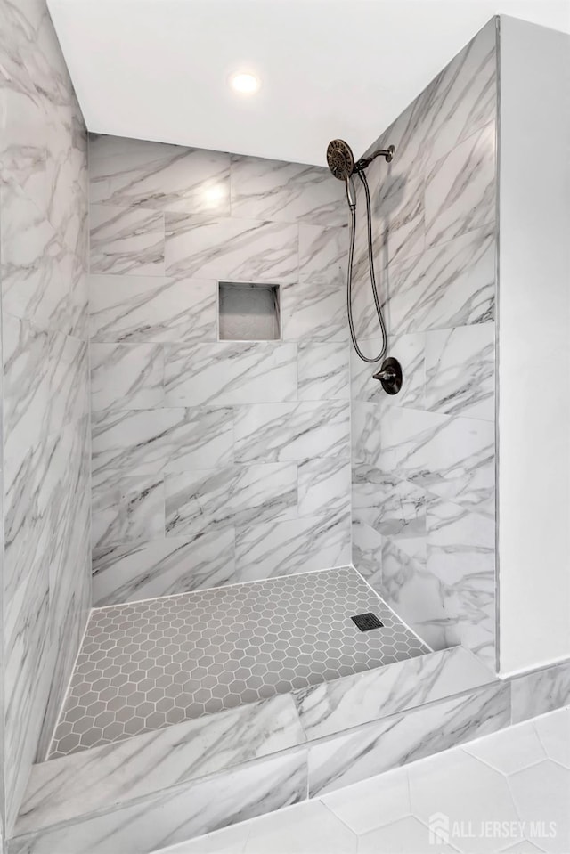 bathroom featuring a tile shower and recessed lighting