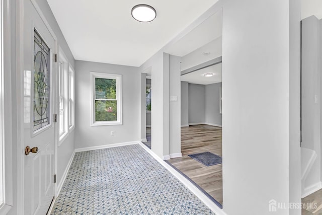 corridor featuring baseboards