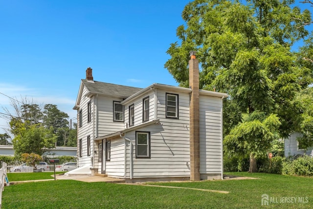 rear view of property with a chimney