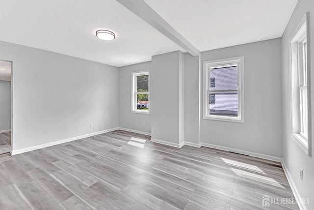 empty room featuring light wood-style floors and baseboards