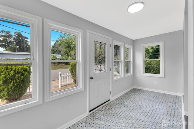 doorway to outside featuring baseboards