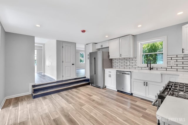 33 Stockton Ave, Jamesburg, NJ 08831 - kitchen featuring appliances with stainless steel finishes, light countertops, tasteful backsplash, plenty of natural light, and recessed lighting
